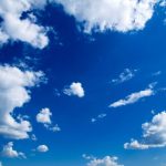 Blue sky background with tiny clouds